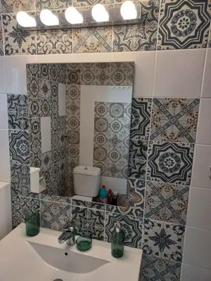 a bathroom with a sink and tiles on the wall at Chania Town Center with Balcony by MPS in Chania Town