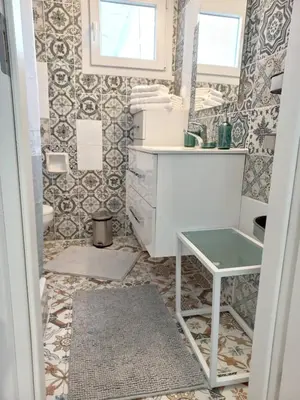 a bathroom with a sink and a mirror at Chania Town Center with Balcony by MPS in Chania Town