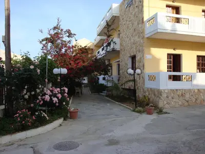 a building with flowers and plants in front of it at Anniko in Stalos