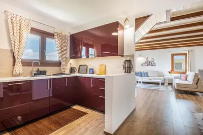 a kitchen with purple cabinets and a living room at Villa Rose in Chania Town