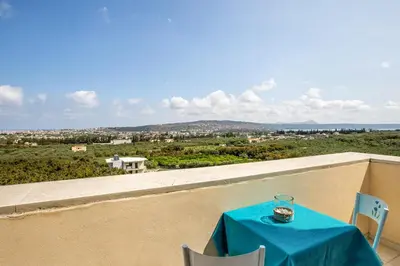 a table with a blue table cloth sitting on a ledge at Villa Rose in Chania Town