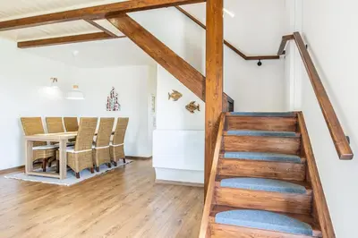 a staircase in a living room with a table and chairs at Villa Rose in Chania Town