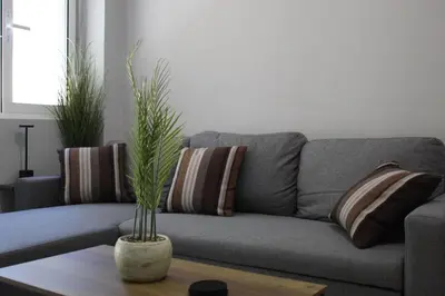 a living room with a gray couch with pillows at Unique Apartment 3 in Chania Town
