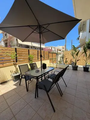a table and chairs with an umbrella on a patio at Unique Apartment 2 in Chania Town