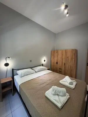 a bedroom with a large bed with towels on it at Unique Apartment 2 in Chania Town