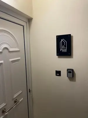 a door to a room with a sign on the wall at Pnoé studio, Chania Center in Chania Town