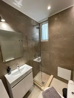 a bathroom with a sink and a shower at Pnoé studio, Chania Center in Chania Town
