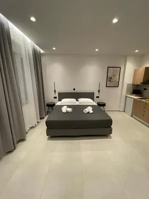 a bedroom with a bed with two towels on it at Pnoé studio, Chania Center in Chania Town