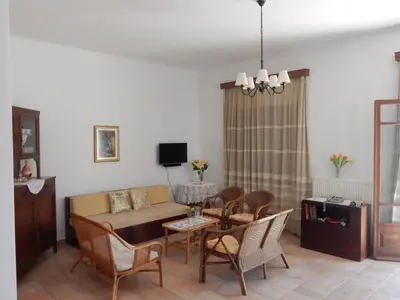 a living room with a couch and a table and chairs at Kaina Villa in Vamos