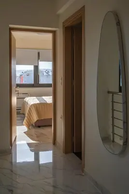 a bedroom with a bed and a mirror on the wall at Thalo Maison in Chania Town
