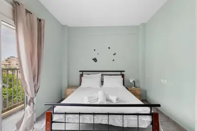 a bedroom with a bed and a window at Litsa's Maisonette Near Sea - City Center in Chania Town