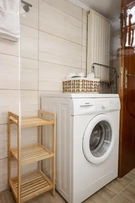 a laundry room with a washing machine and a shelf at Sellianos Apartment In Kalyves -BY APOKORONAS VILLAS in Kalyves