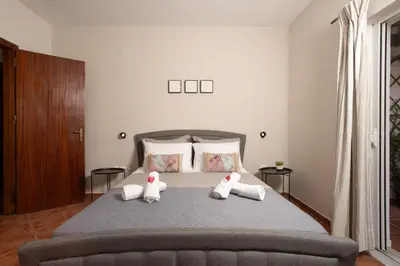 two stuffed animals sitting on a bed in a bedroom at Sellianos Apartment In Kalyves -BY APOKORONAS VILLAS in Kalyves