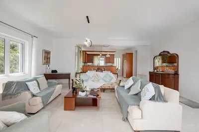 a living room with two couches and a table at Olive Ηouse, Quiet, Cozy, mountain view, family in Milonianá