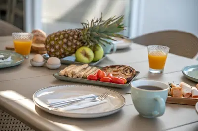a table topped with plates of food and fruit at Casa Elea in Kissamos