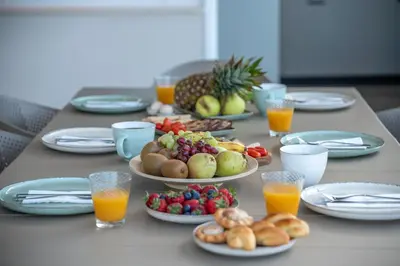 a table with plates of food and fruit on it at Casa Elea in Kissamos