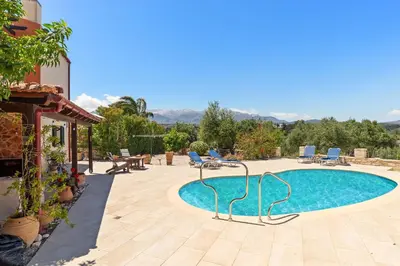 a swimming pool in the middle of a yard at Villa Calista In Aspro -BY APOKORONAS VILLAS in Koprána
