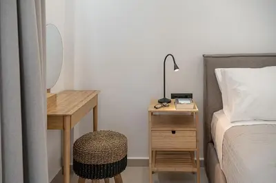 a bedroom with a bed and a table with a lamp at Petra Retreat Residence in Daratso