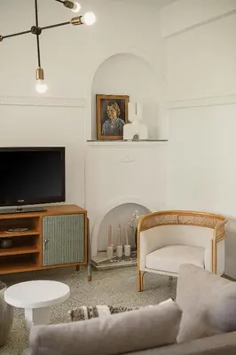 a living room with a couch and a tv at Eva's Apartment in Chania Town
