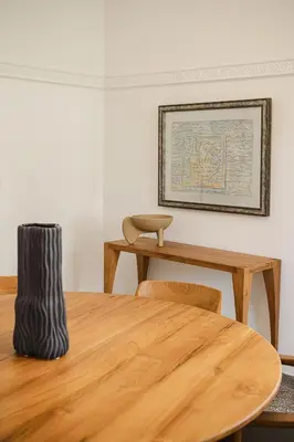 a dining room with a table and a picture on the wall at Eva's Apartment in Chania Town