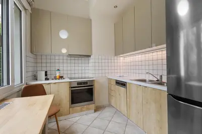 a kitchen with wooden cabinets and a table in it at Architects Oasis in Chania Town