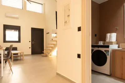 a kitchen and living room with a washing machine at Ikaros City Loft in Chania Town