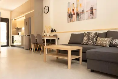 a living room with a couch and a table at Ikaros City Loft in Chania Town
