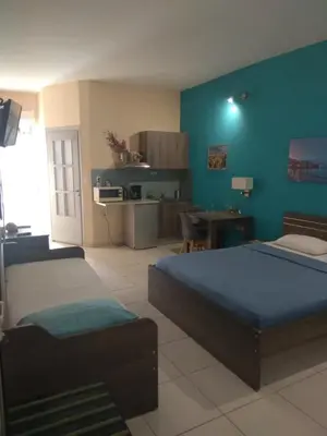a large room with two beds and a kitchen at Blue Studios in Chania Town