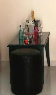 a table with bottles and glasses on top of it at Blue Studios in Chania Town