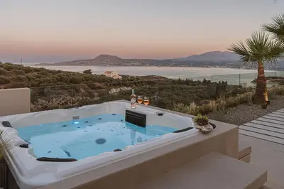 a hot tub on a balcony with a view of the ocean at Villa Niolos I in Marathi