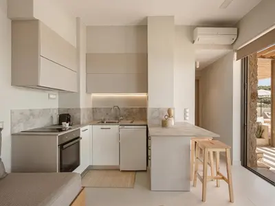 a kitchen with white cabinets and a counter at Villa Niolos I in Marathi