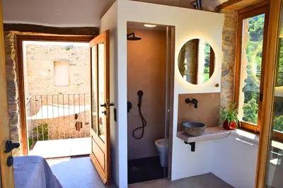 a bathroom with a tub and a toilet and a window at Mozaik House