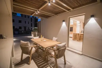 a dining room with a wooden table and chairs at Kalmar mindful living in Palaiochóra