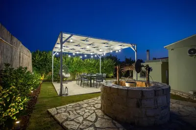 a patio with a table and a white canopy at Be Crete - Villa Vayanna in Sirílion