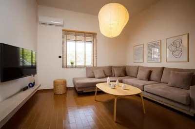 a living room with a couch and a table at Mantarini House in Chania Town