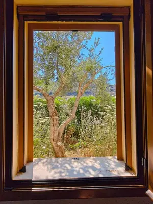 a window with a view of a tree at Kalives pearl suite in Kalyves