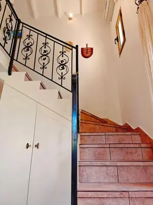 a staircase in a house with a stair case at Kalives pearl suite in Kalyves