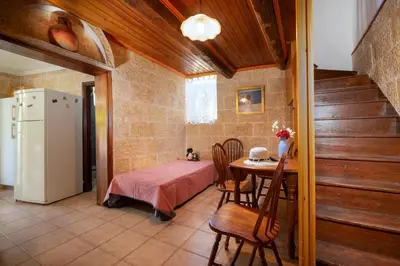 a kitchen with a table and a refrigerator in a room at Galatas Maisonette in Galatás