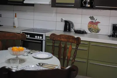 a kitchen with a table with a bowl of oranges on it at Stone House by the Sea in Tavronitis