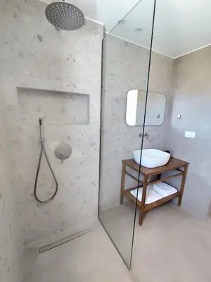 a bathroom with a shower with a toilet and a sink at Ataraxia Villa in Spiliá