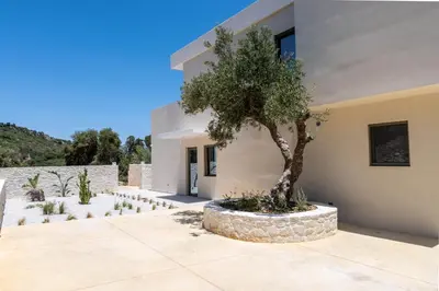 a house with a tree in front of it at Ataraxia Villa in Spiliá