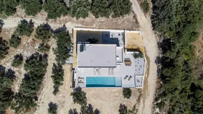 an overhead view of a building with a pool at Ataraxia Villa in Spiliá