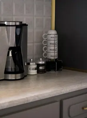 a counter top with a coffee maker and a coffeemaker at IKARUS apartment with courtyard & pool in Chania in Stérnai