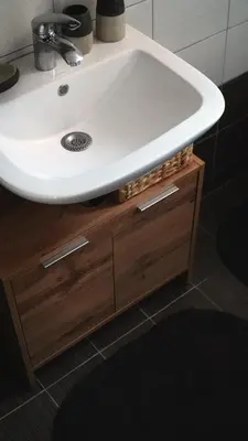 a white sink sitting on top of a wooden cabinet at IKARUS apartment with courtyard & pool in Chania in Stérnai