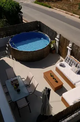 a swimming pool on the roof of a house at IKARUS apartment with courtyard & pool in Chania in Stérnai