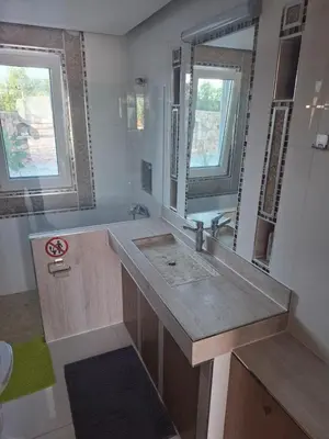 a bathroom with a sink and a large mirror at Villa Dadis in Chania