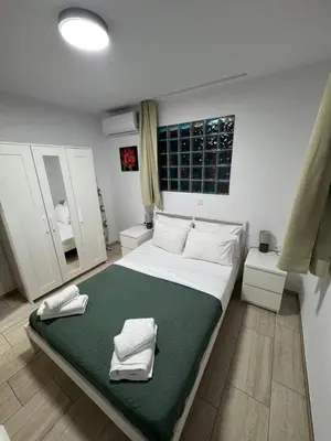 a bedroom with a large bed with towels on it at Villa Dadis in Chania