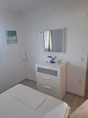 a white bedroom with a bed and a sink at Villa Dadis in Chania
