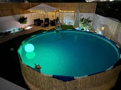 an overhead view of a swimming pool at night at Vila Alexandros in Souda