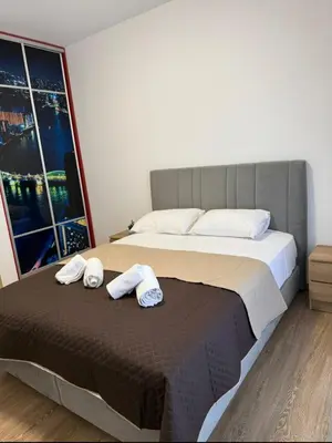 a bedroom with a bed with two towels on it at Serenity apartment sea view in Souda